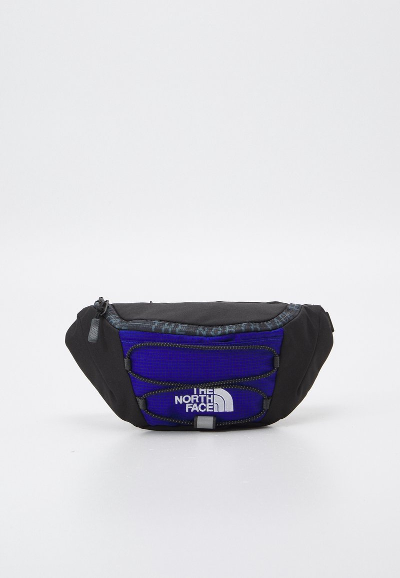 Sac banane compact noir et bleu avec fermeture éclair, cordons élastiques et logo blanc The North Face sur le panneau avant.