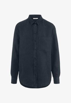 Mustassa napituksella varustettu pitkähihainen paita, jossa on kaulus ja etutasku. Valmistettu pehmeästä kankaasta, jossa on hieman teksturoitu pinta.