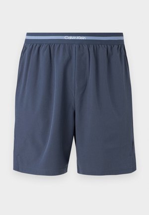 Marineblaue Herrenboxershorts mit einem elastischen Bund mit hellblauen Streifen und einem weißen Calvin Klein-Logo mittig vorne.