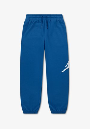 Blaue Jogginghose mit elastischem Bund, Kordelzug, Bündchen an den Knöcheln und einer weißen springenden Figurengrafik am linken Bein.
