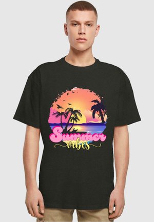 Black T-shirt featuring a graphic design of a sunset over palm trees with "Summer Vibes" text in pink and yellow, printed on the front.