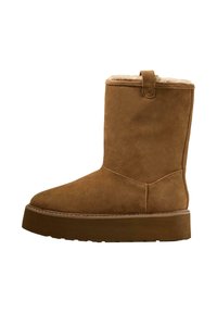 Brown suede ankle boot with a rounded toe, soft inner lining, and a thick platform sole. Features a small pull tab at the back.