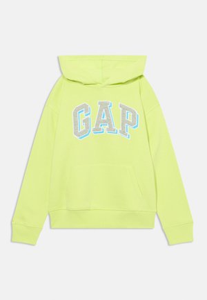 Kapa sa kapuljačom u svijetloj neonskoj žutoj boji s prednjim džepom. Sadrži "GAP" logotip u sivoj boji s plavim naglaskom. Pamuk, ležeran dizajn.