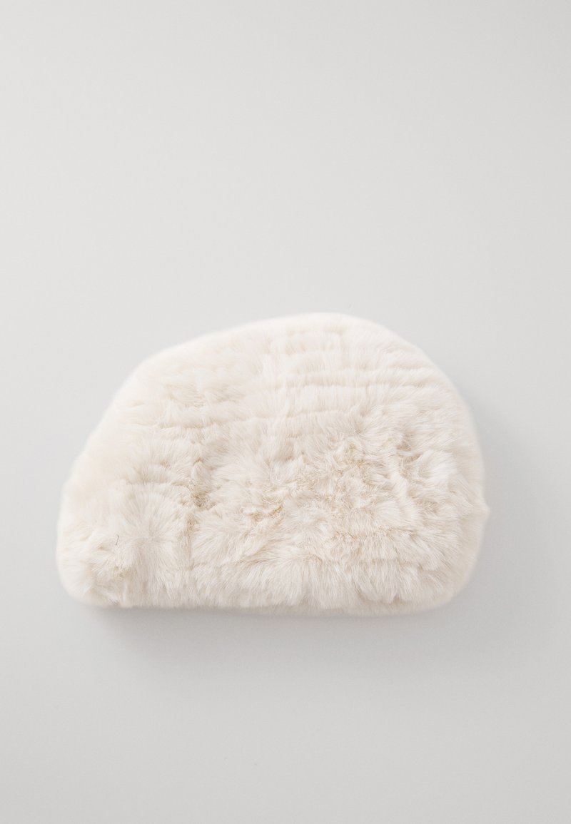 Soft, white, fluffy half-moon shaped pouch or cosmetic bag on a light gray background.