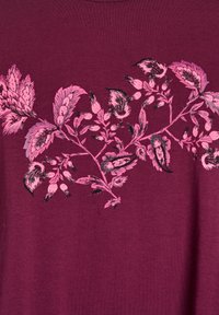 Burgundy shirt with a floral design in pink and black. Features intricate leaf patterns and a soft, smooth texture.