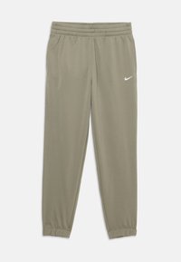 Gaišolīšu zaļas Nike sporta bikses ar elastīgu jostu, sānu kabatām un elastīgiem piegriezumiem, uz labās augšstilba ir neliels balts Nike swoosh.
