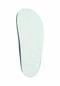 White rubber sole with textured pattern and brown felt lining, featuring a rounded edge and embossed brand logo.