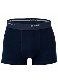 Boxer in cotone blu navy con morbido elastico in vita recante il nome del marchio "GANT" in bianco, design aderente e senza fantasie.