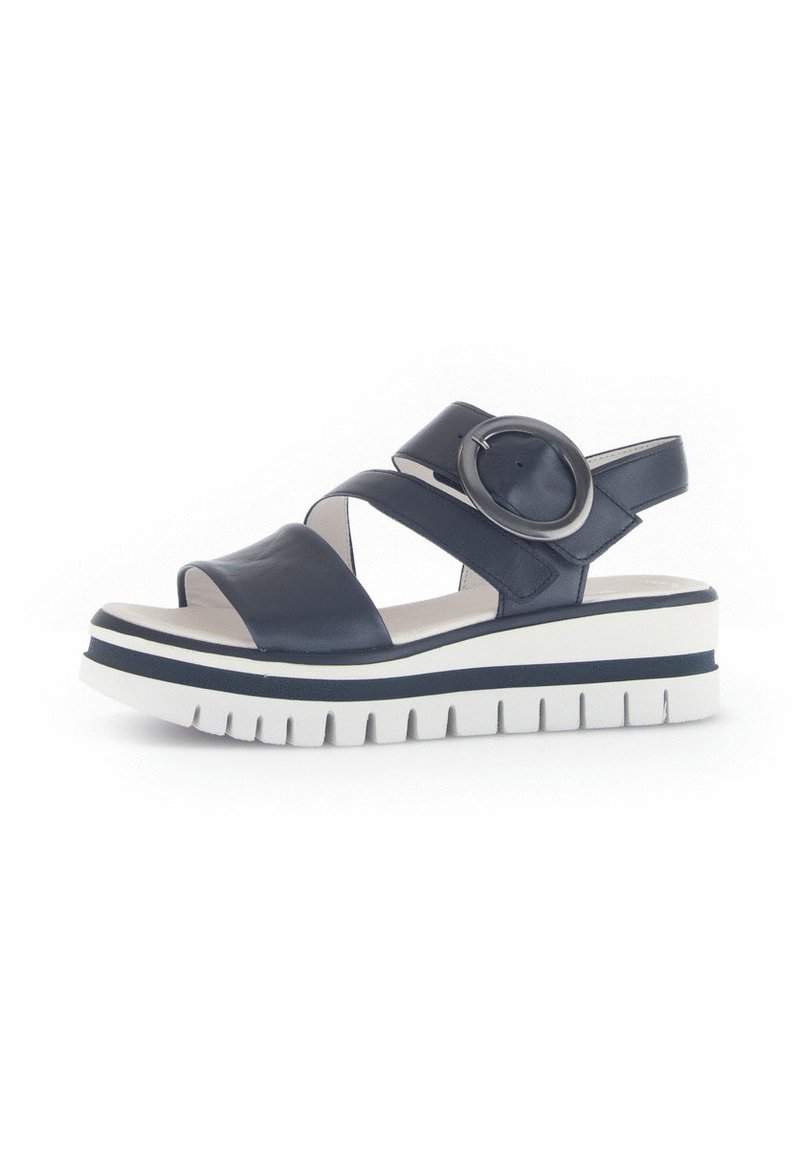 Navy leather sandal featuring cross straps, circular accent, and a thick white sole with navy accent stripes and a textured bottom.
