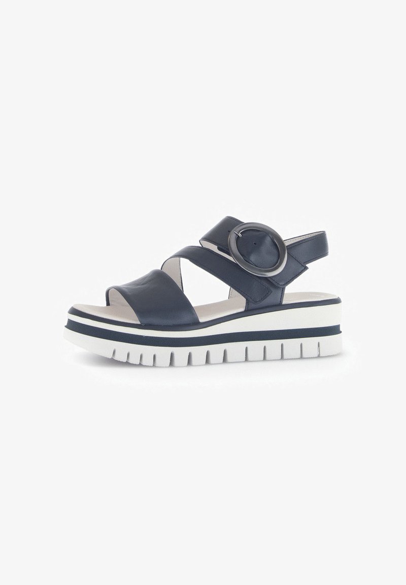 Navy leather sandal featuring cross straps, circular accent, and a thick white sole with navy accent stripes and a textured bottom.