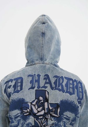 Denim jacket with a hood, light blue color, featuring large dark blue "ED HARDY" text and intricate rose and skull embroidery on the back.