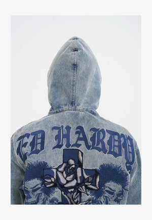 Denim jacket with a hood, light blue color, featuring large dark blue "ED HARDY" text and intricate rose and skull embroidery on the back.