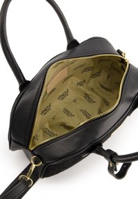 Black leather handbag with textured exterior, featuring a gold zipper and light brown interior lined with printed branding.