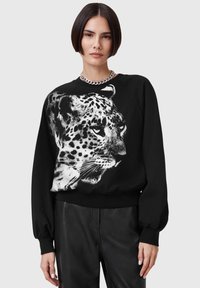 Felpa nera con una grande grafica di un leopardo bianco sul davanti. Disegnata con una vestibilità rilassata e polsini a costine, offre una texture morbida.