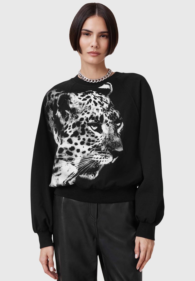 Felpa nera con una grande grafica di un leopardo bianco sul davanti. Disegnata con una vestibilità rilassata e polsini a costine, offre una texture morbida.