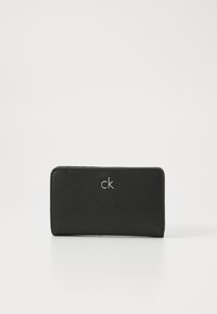 Black wallet made of smooth leather featuring a stitched edge and a silver "ck" logo on the front. Rectangular shape, compact design.