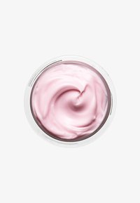 Light pink cream with a smooth, creamy texture, swirled in a circular silver-rimmed container reflecting light.