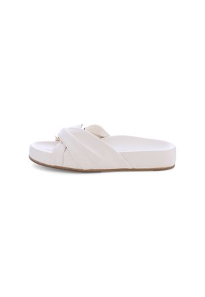 White slip-on sandal with a cross-over strap design, smooth synthetic material, flat sole, and subtle textured accents on straps.