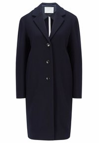 Manteau en laine noire mi-longueur jusqu'aux genoux, manches longues, trois boutons à l'avant et col à revers cranté.