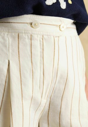 Cream-colored fabric featuring thin, horizontal stripes in light brown. Waistband secured with two white buttons. Pleated design detail.