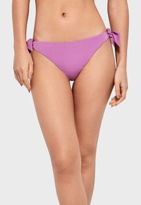 Parte inferior de bikini púrpura con lazos en las caderas, una textura suave y un corte bajo para una cobertura mínima.