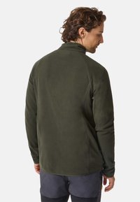 Giacca in pile verde scuro con colletto alto, tessuto testurizzato e maniche raglan. La vista posteriore mostra una superficie liscia e uniforme senza hardware visibile.