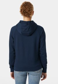 Sudadera azul marino con capucha ajustable, mangas raglán y dobladillo acanalado. El material parece suave, adecuado para el uso casual.