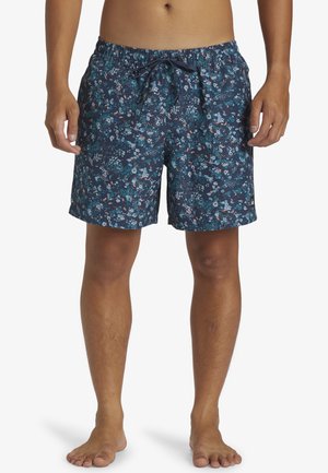 Bañadores azul marino con un patrón floral en varios colores. Cuenta con una cintura elástica y cordón, corte hasta la rodilla y tejido ligero.