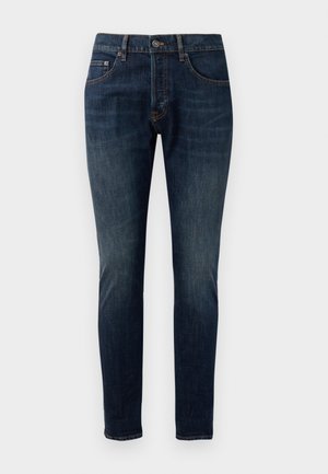 Jeans skinny in denim blu scuro con un effetto sbiadito, design a cinque tasche, chiusura con bottone in metallo e dettagli con cuciture a contrasto.
