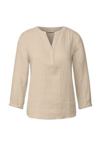 Cremefarbene Bluse mit langen Ärmeln aus strukturiertem Stoff, mit Stehkragen und einer halben Knopfleiste. Weicher, lockerer Schnitt.