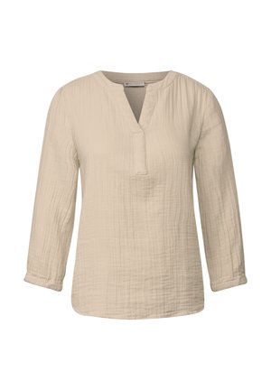Blusa de manga larga color crema, confeccionada con una tela texturizada, con cuello mao y una botonera a media altura. Ajuste suave y holgado.