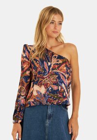 Een top met één schouder in een bloemenprint, met levendige blauw-, roze- en oranje-tinten. Gemaakt van gestructureerde stof met een ruime pasvorm en lange mouwen.