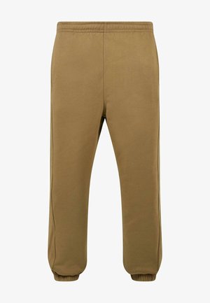Bruine fleece joggingbroeken met een elastische tailleband, taps toelopende pijpen en ribgebreide boorden. Zachte textuur met zijnaaddetails.