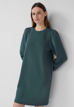 Dunkelgrün sweatshirt Kleid mit langen Ärmeln, Rundhalsausschnitt und dezenten Seitenschlitzen. Weicher, glatter Stoff mit lockerer Passform.