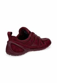Burgundy athletic shoe with mesh and suede materials, rounded shape, textured sole, and pull tab at the heel, featuring cutout accents.