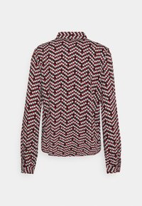 Blouse à manches longues avec un petit motif floral en chevron rouge, noir et blanc et un col montant, vue de dos sur fond blanc.