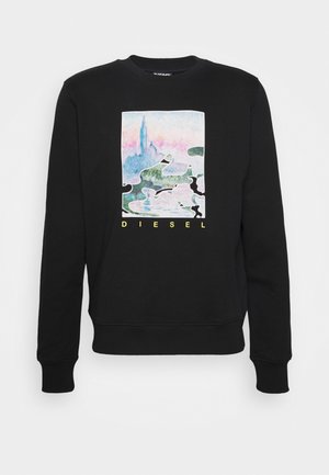 Sweat-shirt noir avec un graphisme abstrait de paysage urbain pastel et de grandes pièces de puzzle, texte "DIESEL" en jaune sous le design.