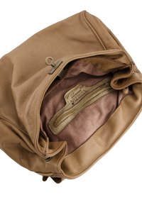 Brown leather bag interior with smooth texture, featuring a zip pocket and soft pink lining. Brass hardware detail visible at the opening.