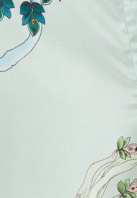 Silky mint fabric featuring intricate floral patterns with blue and green leaves and pink accents along the edges. Smooth texture.