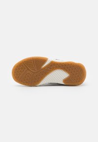 Shoe sole with a gum rubber bottom, featuring a textured pattern for grip. The design includes white and grey sections with a slight curve.
