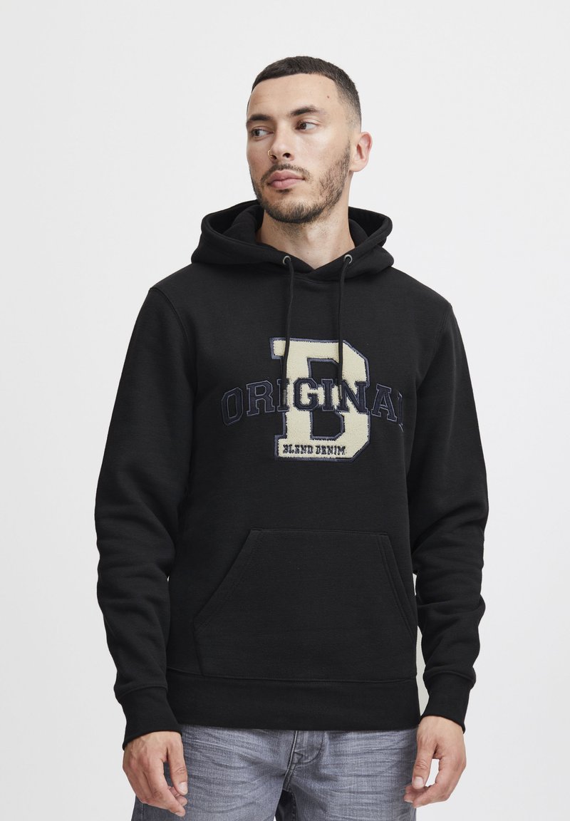 Black hooded sweatshirt with front pouch pocket, featuring an embroidered "B" and "ORIGINAL" text in beige and navy. Soft fabric texture.