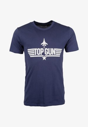 Tummansininen puuvillapaita lyhyillä hihoilla, jossa on valkoinen "TOP GUN" -grafiikka ja lentokonesiluetti tähden yläpuolella edessä.