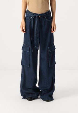 Dark blue denim wide-leg cargo pants with a high waist, tied belt, and two large patch pockets on each side, featuring a textured finish.