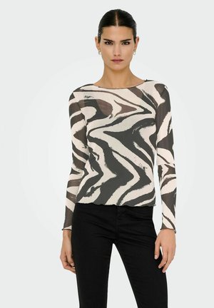 Langsleeve, doorschijnend top met een golvende zwart-witte zebra print. Ronde halslijn en nauwsluitend ontwerp, gecombineerd met zwarte broek.