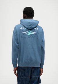 Felpa blu in cotone con cappuccio regolabile, dotata di una stampa logo multicolore sul retro e polsini e orlo a coste.