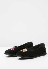 Le scarpe slip-on in suede nero presentano disegni di animali ricamati in rosa, bianco e arancione sulla parte anteriore, con una suola piatta in gomma.
