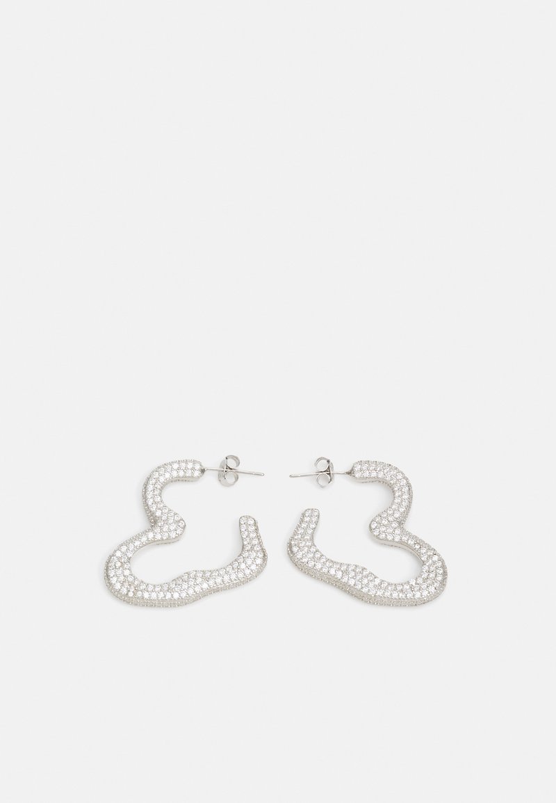 Silver-tone earrings featuring a wavy, abstract design adorned with small, sparkling crystals. Secure stud back closure.