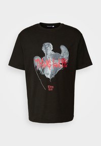 Čierne bavlnené tričko s grafickým potlačou anjelskej postavy a s textom "Thug Life" v tučnej červenej farbe. Dizajn s okrúhlym výstrihom, krátke rukávy.