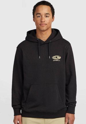 Junger Mann mit kurzen lockigen Haaren, der einen schwarzen O’Neill Hoodie mit Fronttasche und Kordelzügen vor schlichtem hellem Hintergrund trägt.