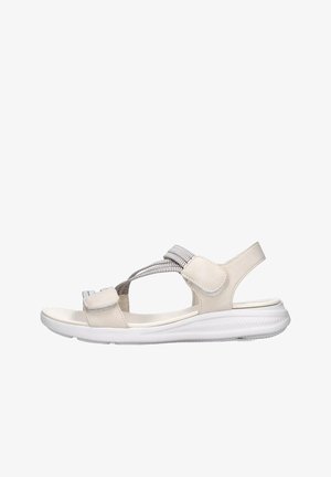 Sandal in beige con una fascia testurizzata, chiusura regolabile in velcro e una suola bianca flessibile. Presenta un profilo basso e un design aperto.